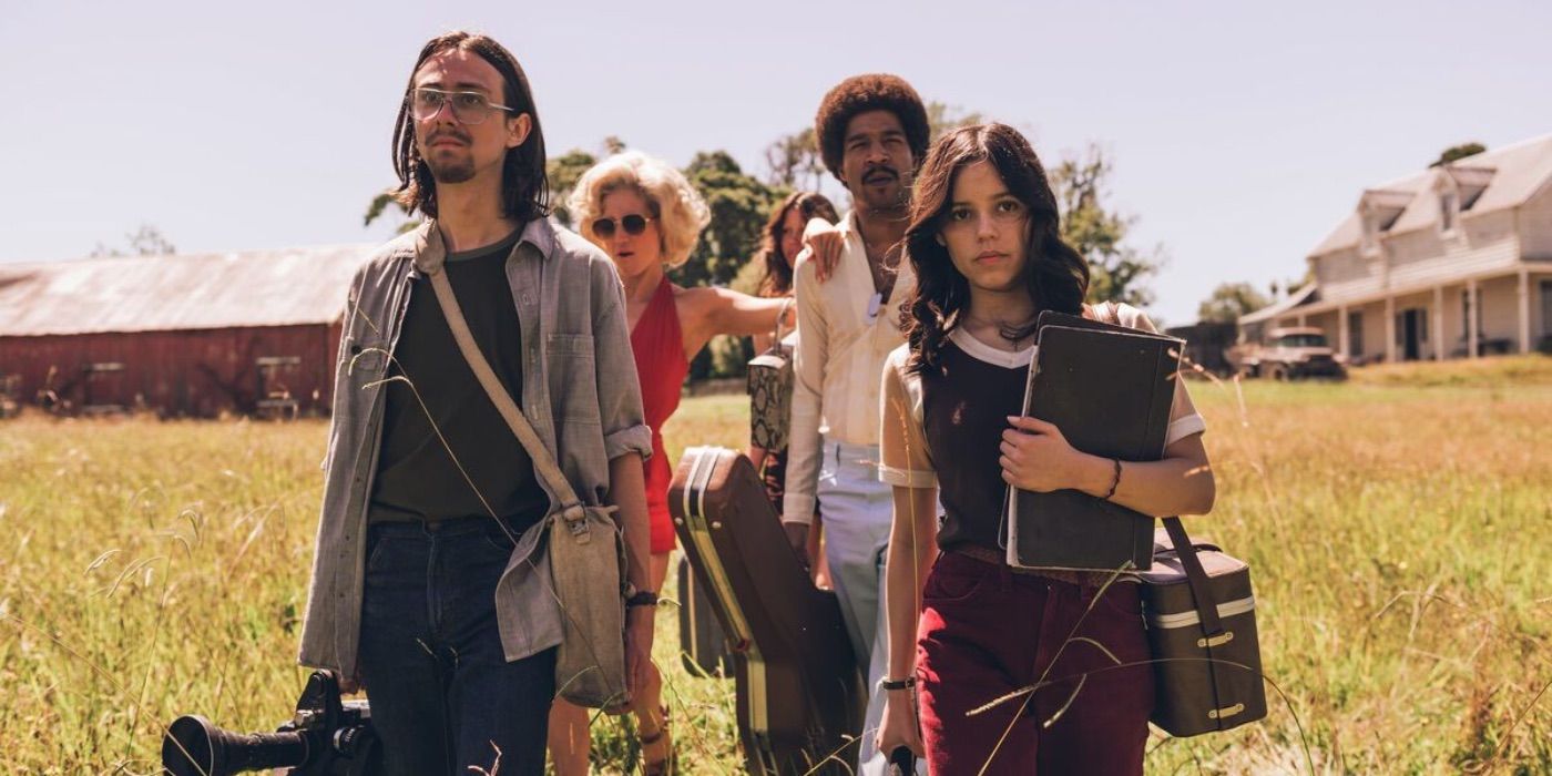 Owen Campbell, Brittany Snow, Scott Mescudi, and Jenna Ortega walking through a field in X