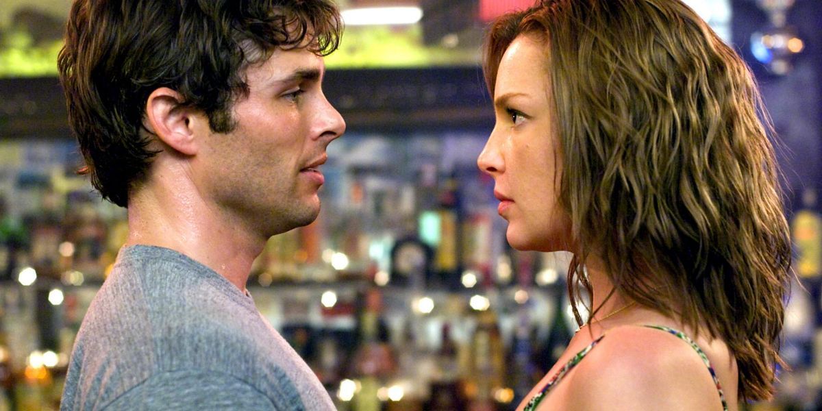 Screenshot of James Marsden and Katherine Heigl staring in a bar from the movie 27 Dresses (2008)