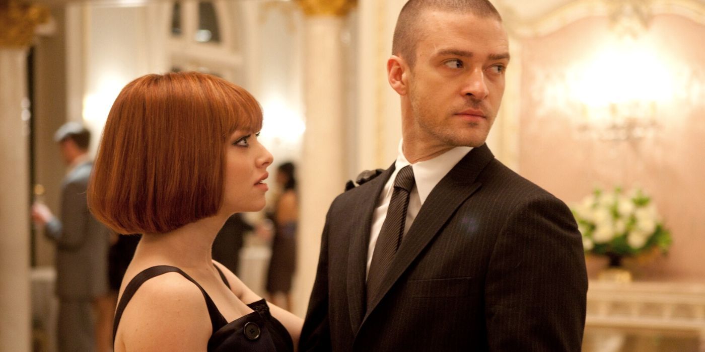 Justin Timberlake holding Amanda Seyfried while looking to the side behind him In Time