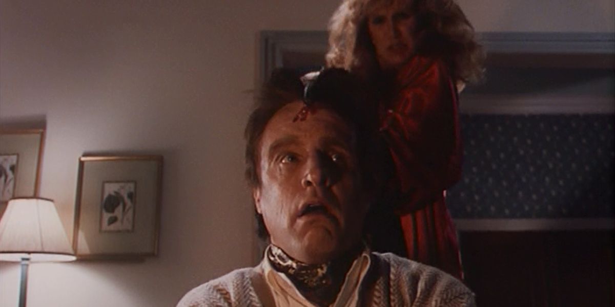 A esposa, interpretada por Mary Ellen Trainor, mata o marido, interpretado por Marshall Bell, com um machado na cabeça no episódio Tales From the Crypt 