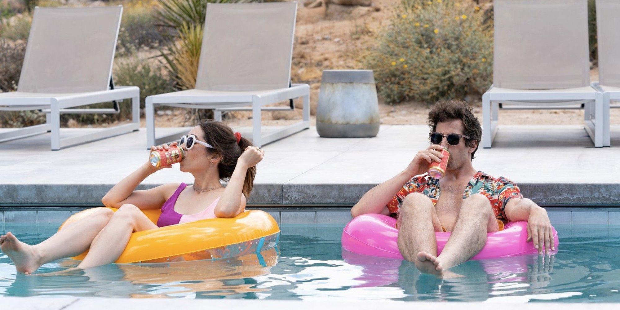 Andy Samberg and Cristin Milioti as Nyles and Sarah drinking while floating on a pool in 'Palm Springs'