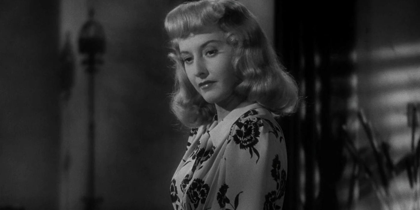 Phyllis Dietrichson (Barbara Stanwyck) looks intently at something off-camera in Double Indemnity