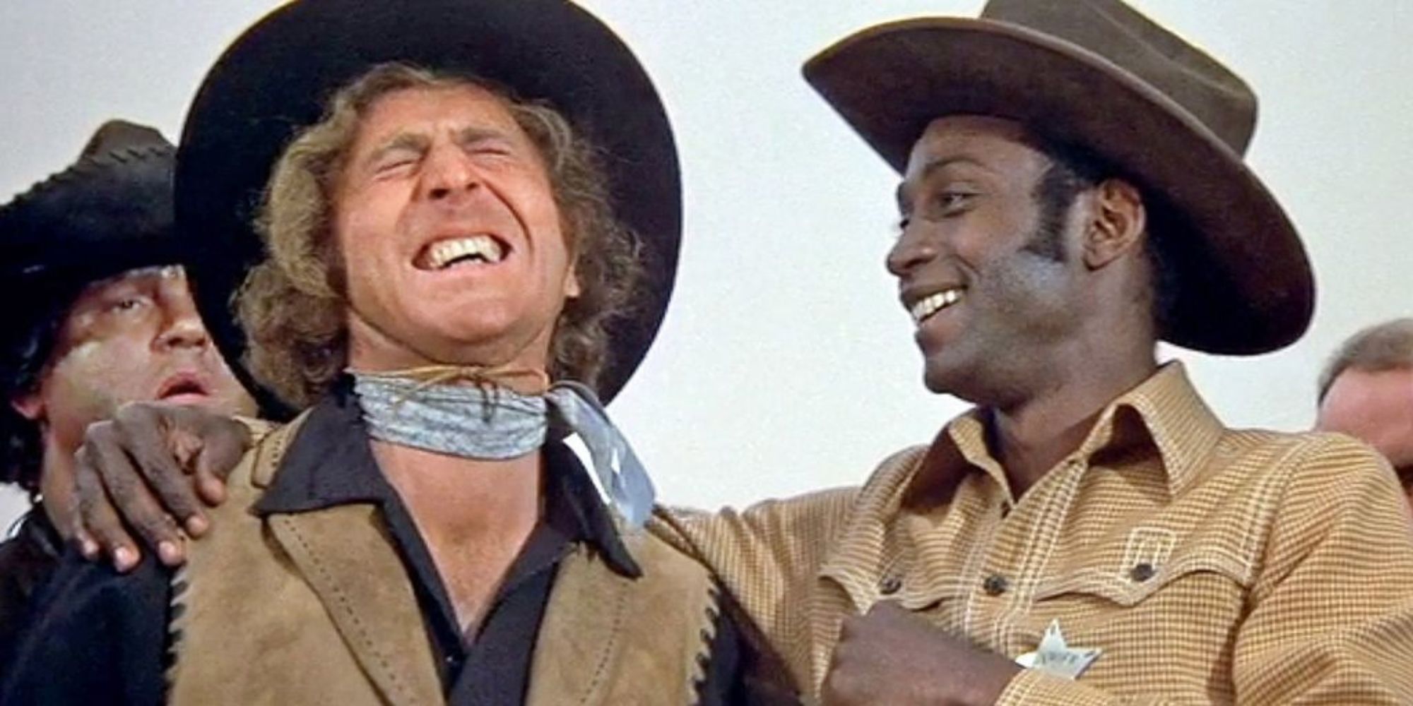 Gene Wilder and Clevon Little laughing in Blazing Saddles