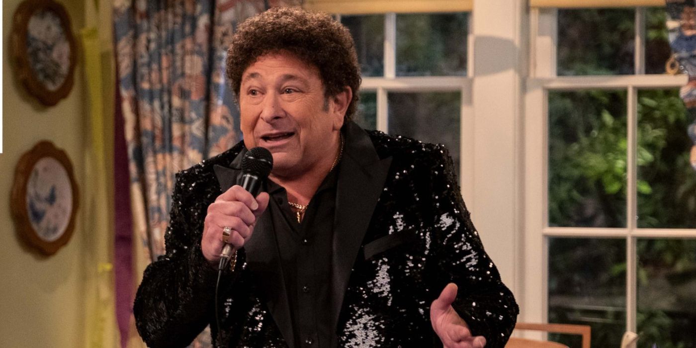 Don Stark as Bob holding a microphone and wearing a sequined black suit in 'That 90s Show'