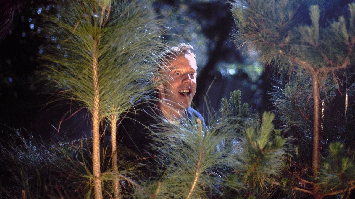 Mike White standing behind a pine tree in Chuck & Buck