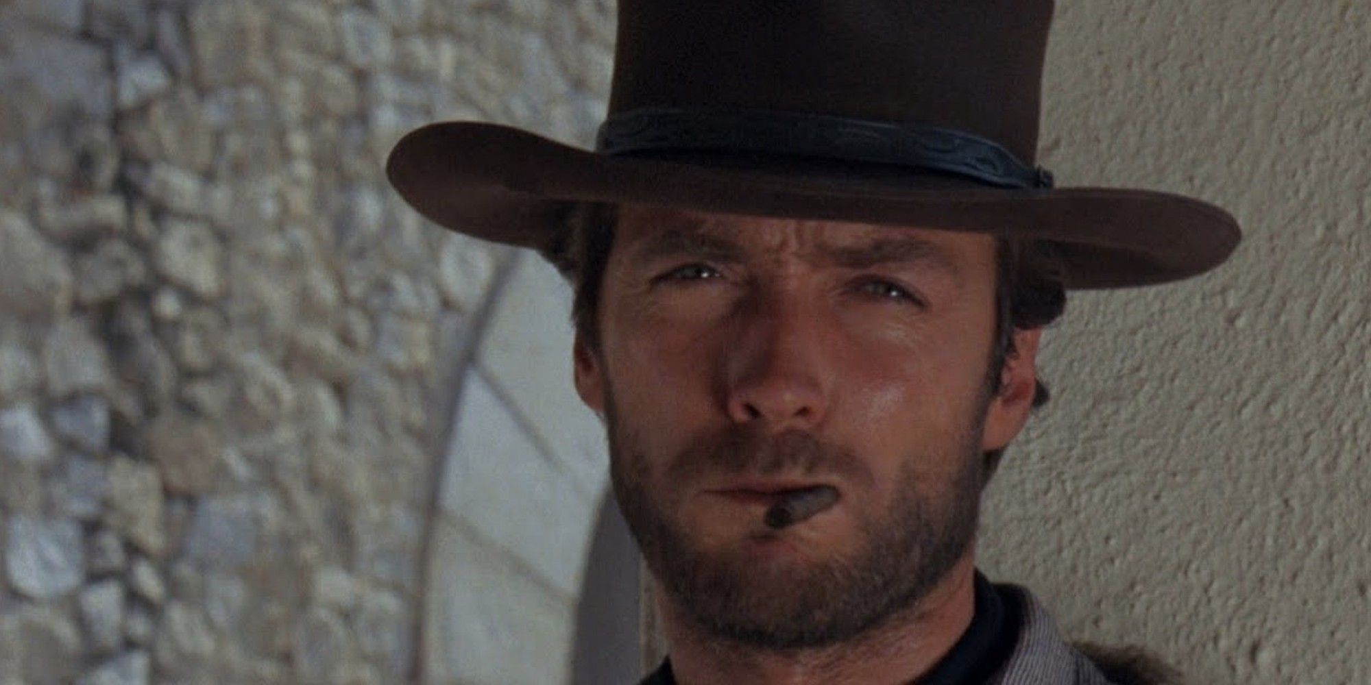 Clint Eastwood smoking a cigarrette and squinting in 'A Fistful of Dollars' (1964)