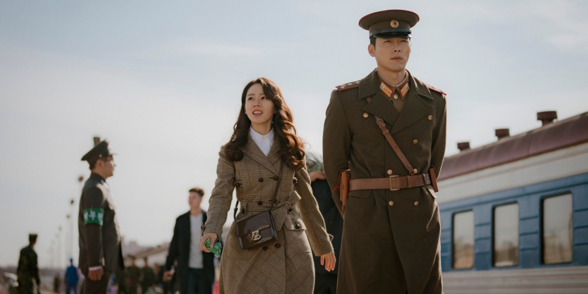 Se Ri and Jeong Hyeok walking side by side in Crash Landing on You.