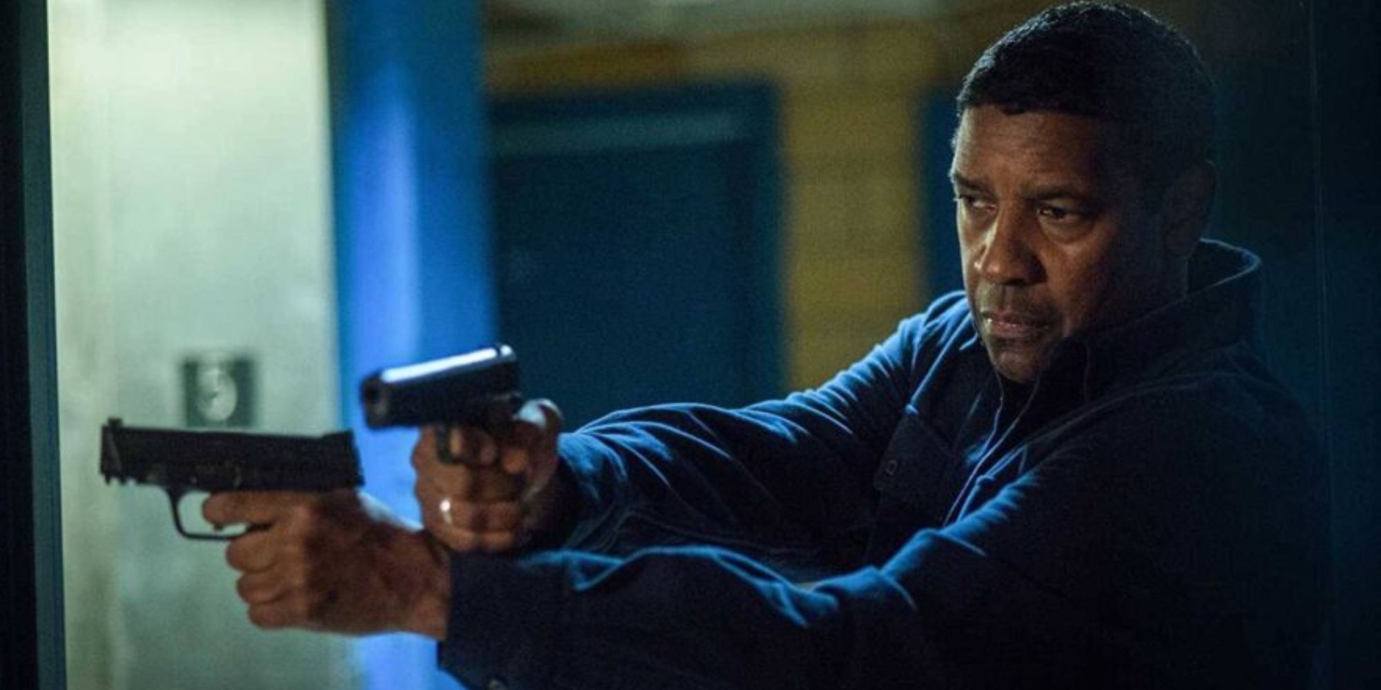 Denzel Washington holding a gun in each hand in The Equalizer 2