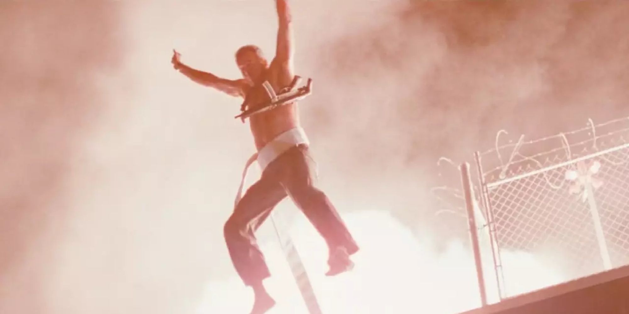 Bruce Willis as John McClane jumping from a roof in Die Hard