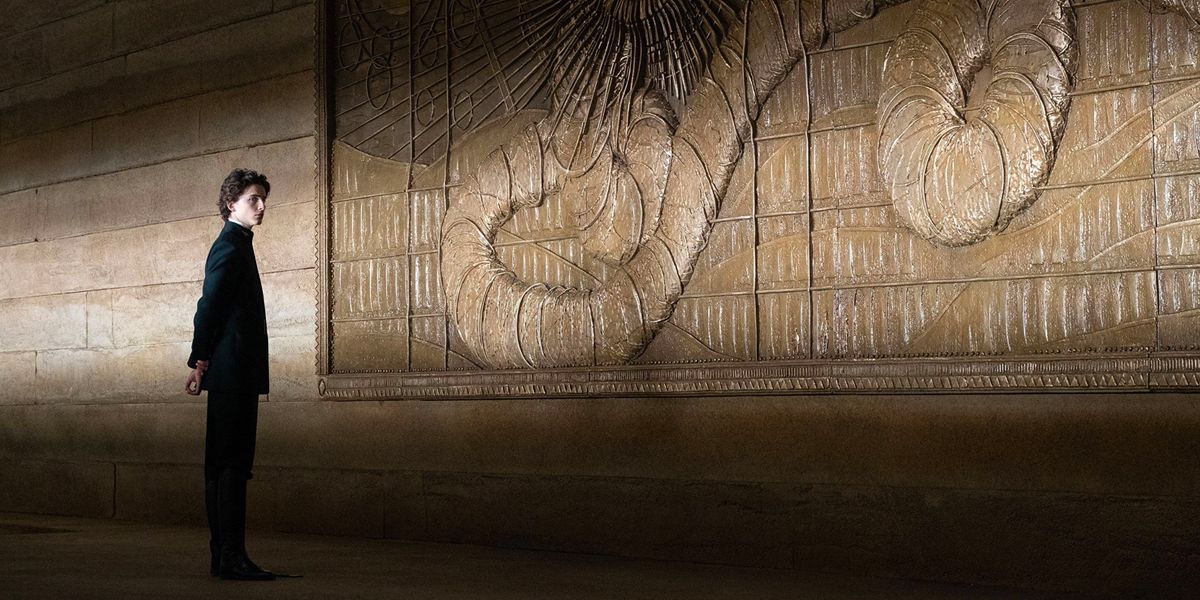 Paul Atreides standing in front of a wall depicting the Maker