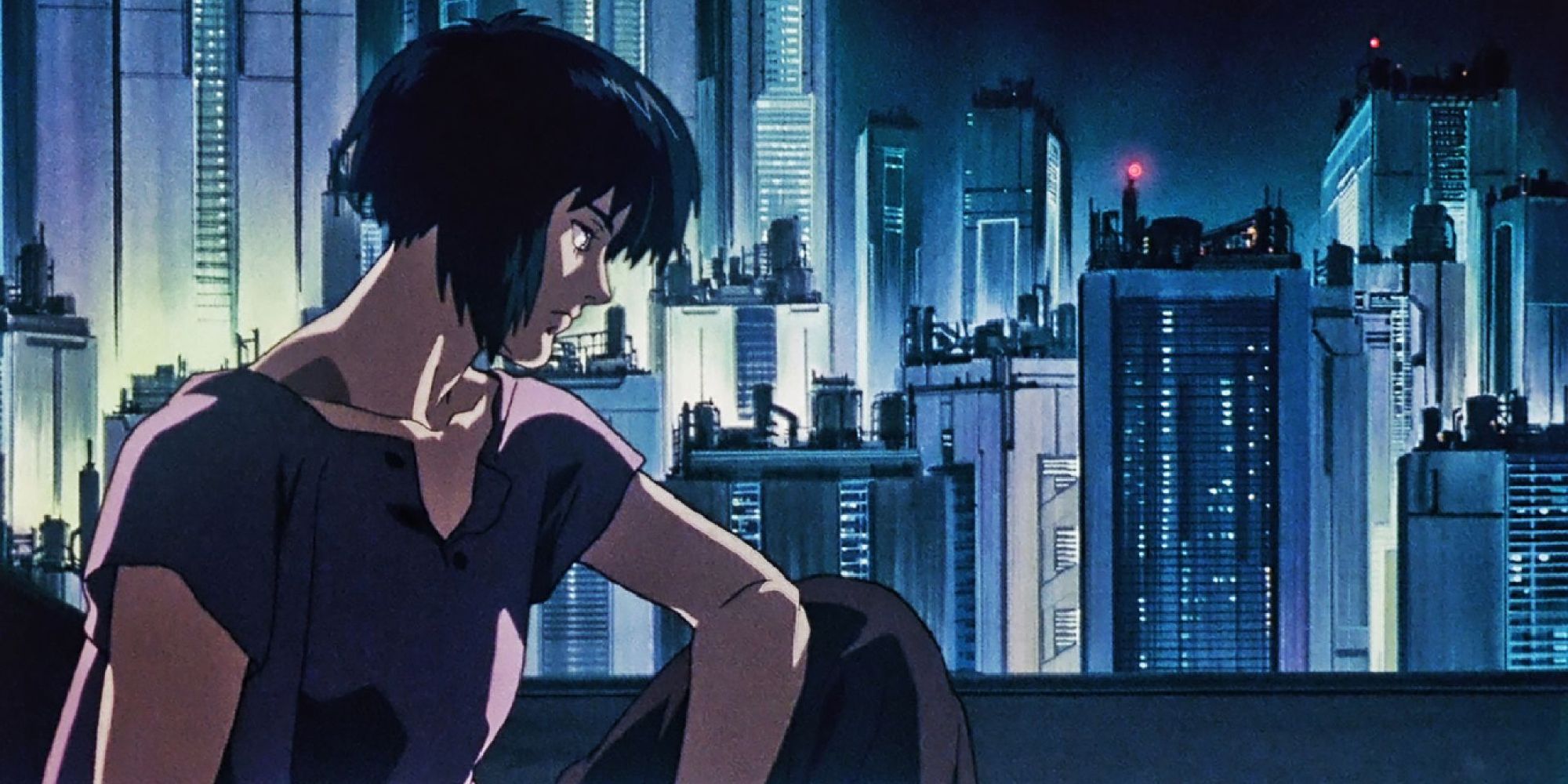 Makoto looking pensive next to a window with a city in the background in Ghost in the Shell - 1995