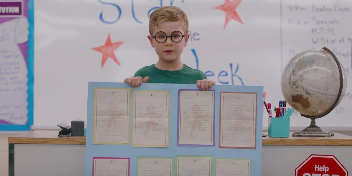 Austin, played by Diesel La Torraca, holding up his class project in 'Ginny & Georgia' Season 1.