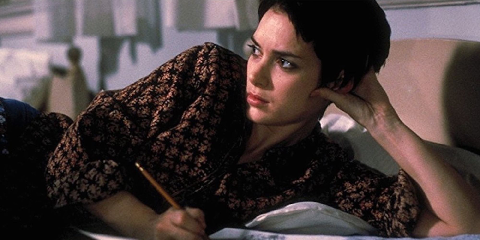 Winona Ryder as Susanna lying in bed and writing in 'Girl, Interrupted'