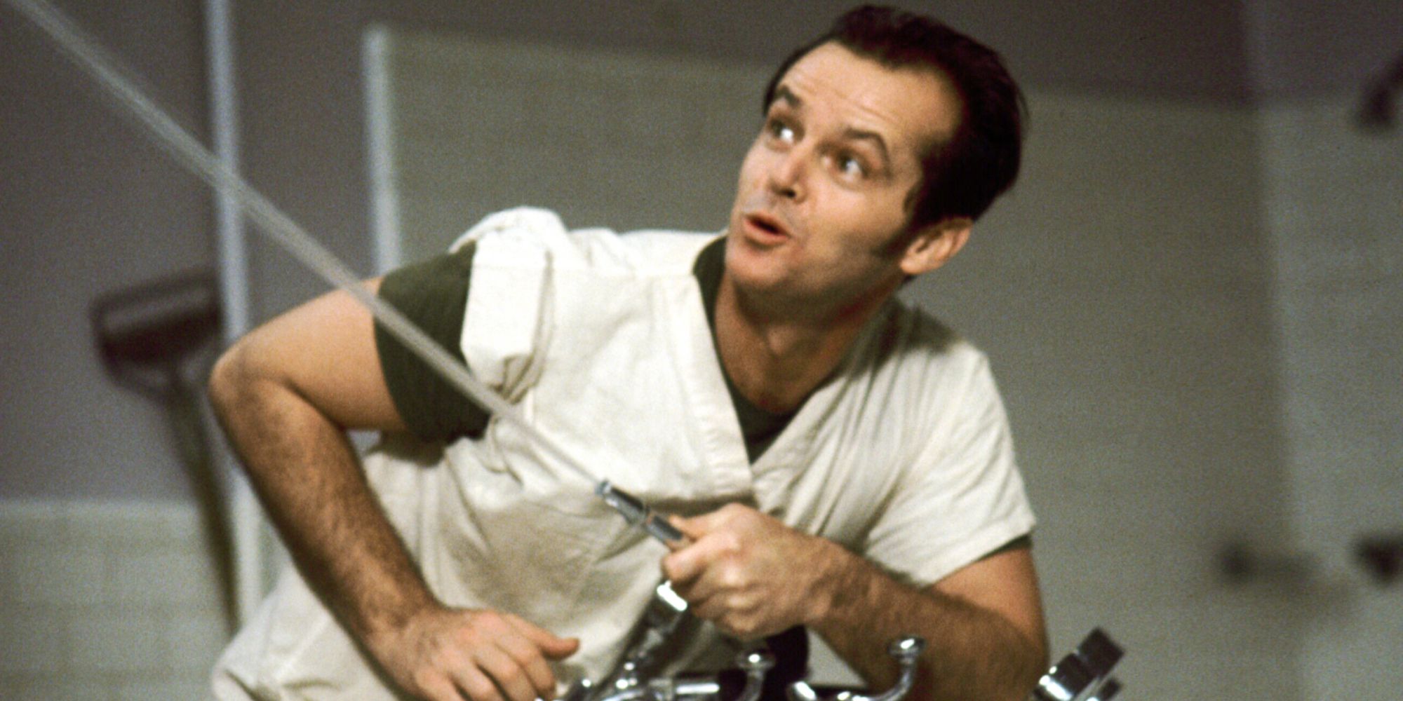 Jack Nicholson as Randle McMurphy aiming a water fountain to his left in One Flew Over The Cuckoo's Nest