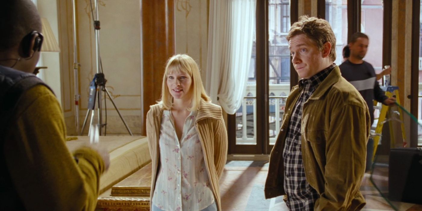 Martin Freeman as John and Joanna Page as Jane listening to someone in Love Actually