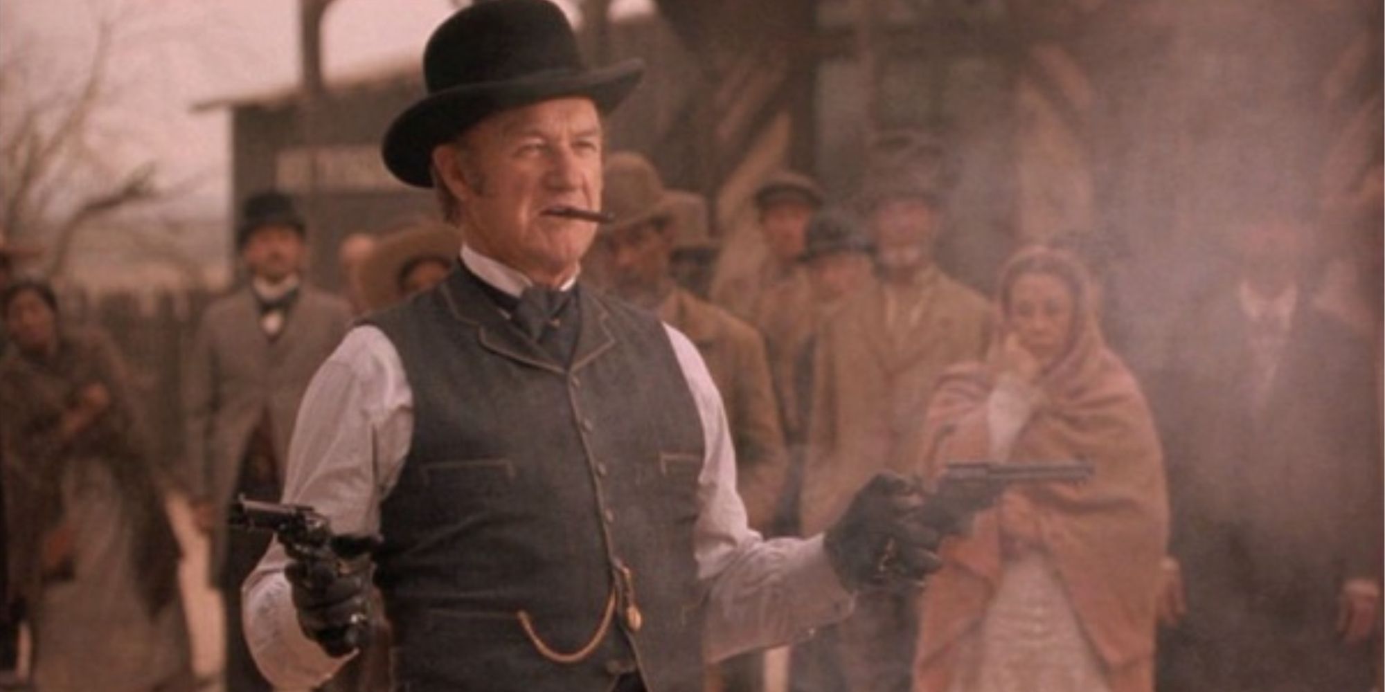 Gene Hackman as John Herod pointing two guns at offscreen targets in The Quick and the Dead