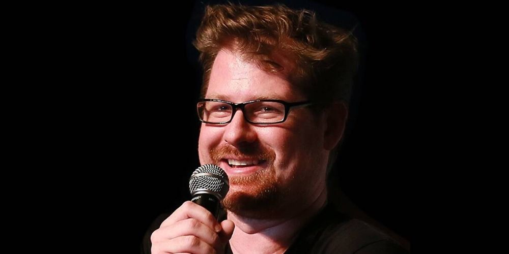 Justin Roiland holding a microphone and smiling