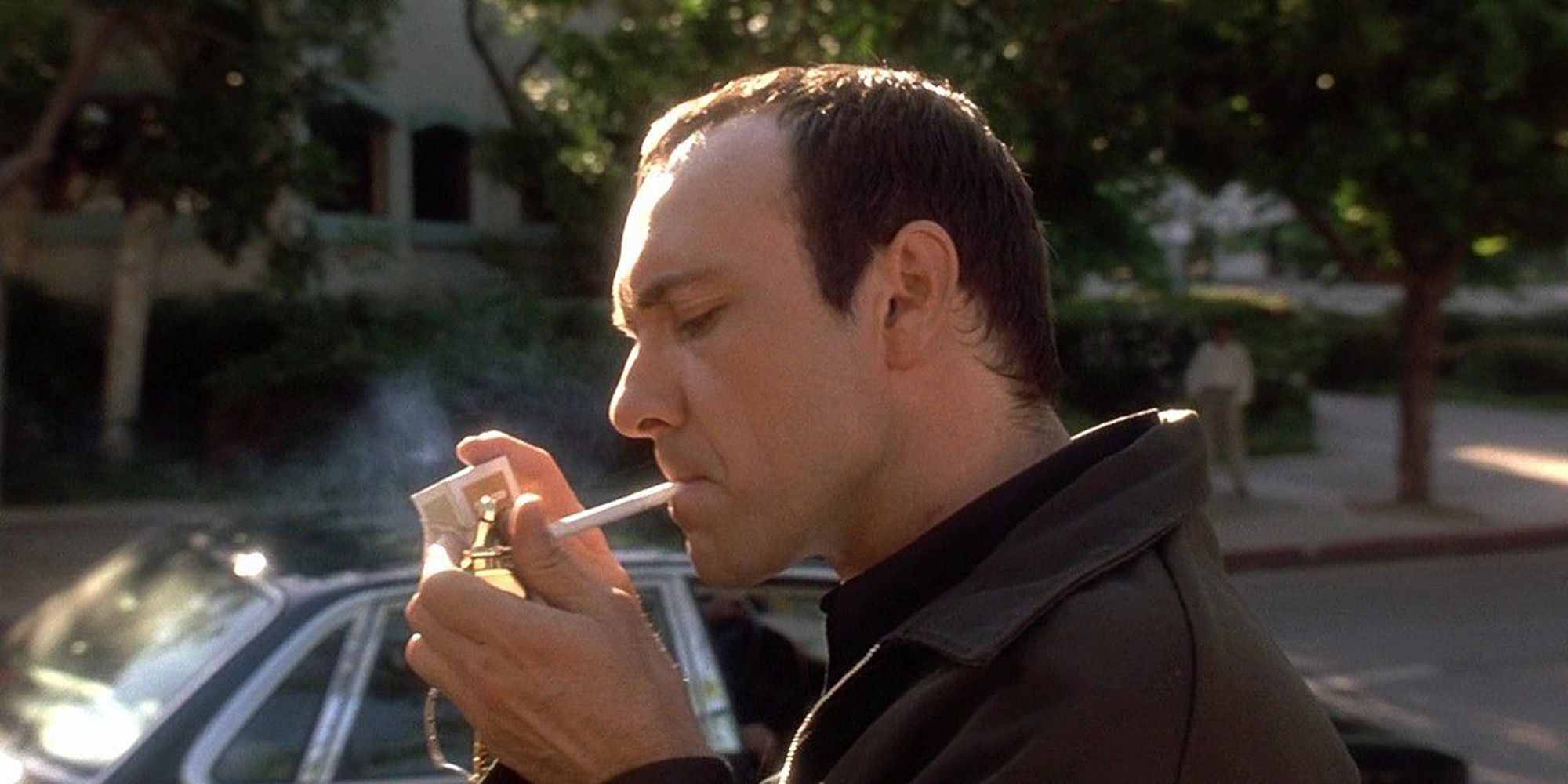 Kevin Spacey smoking cigarette in front of parked car in The Usual Suspects