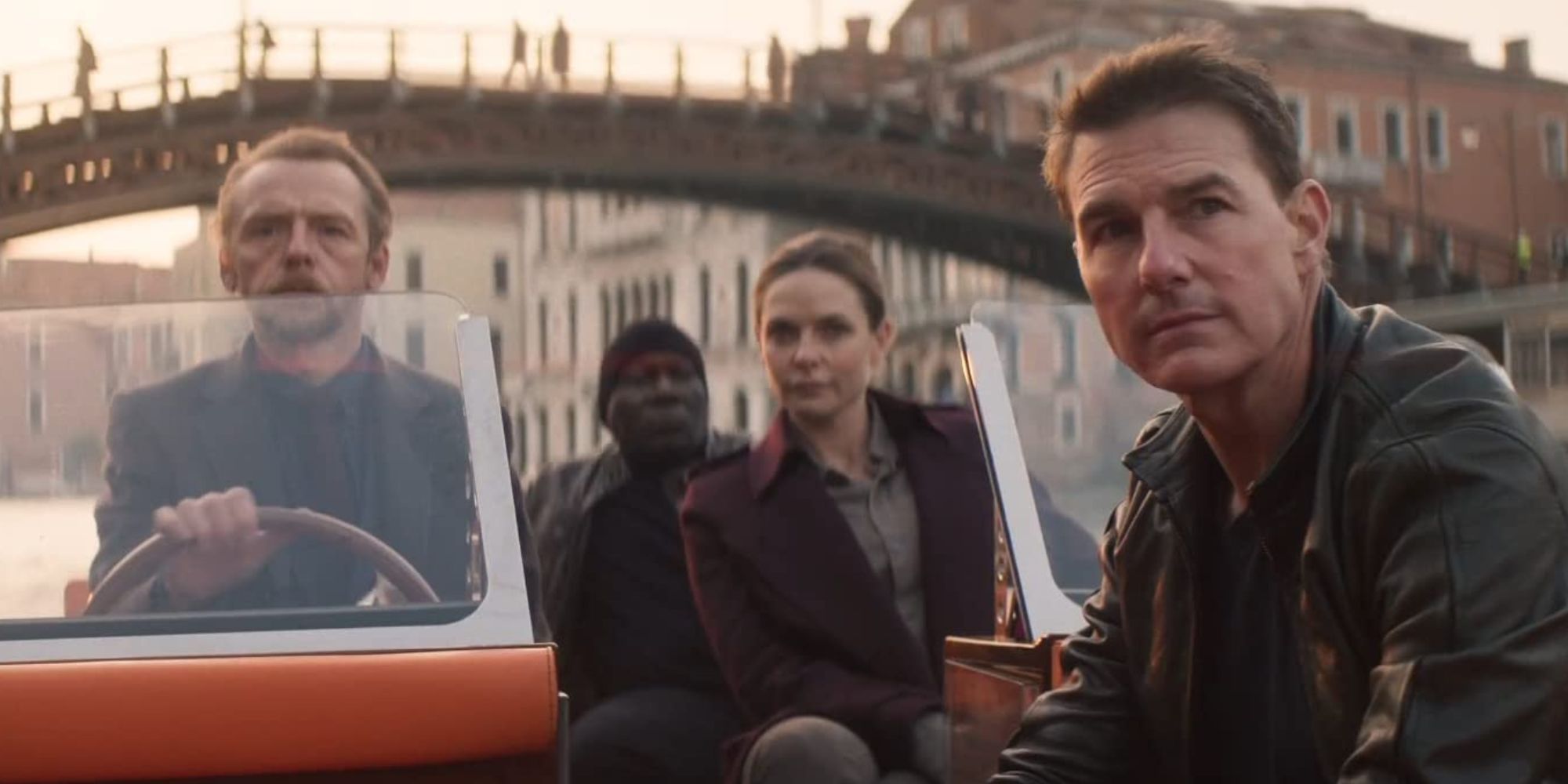 Tom Cruise, Simon Pegg, Ving Rhames and Rebecca Ferguson as Ethan, Benji, Luther, and Ilsa on a boat in Mission: Impossible Dead Reckoning Part One