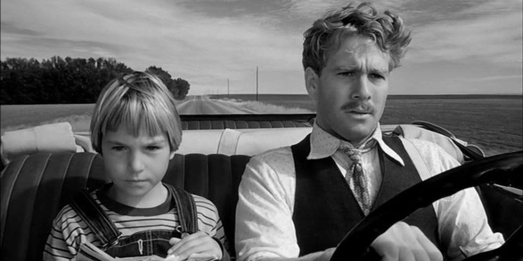 A young girl and a man inside a car in the movie Paper Moon (1973)