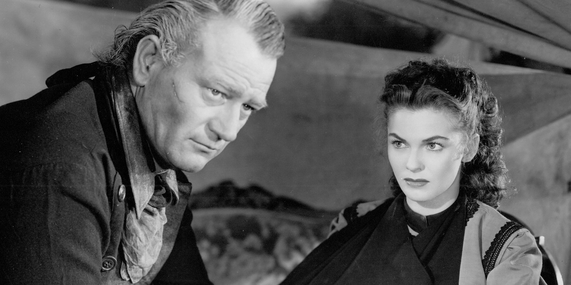 Joanne Dru as Tess Millay looking at John Wayne as Thomas Dunson in Red River