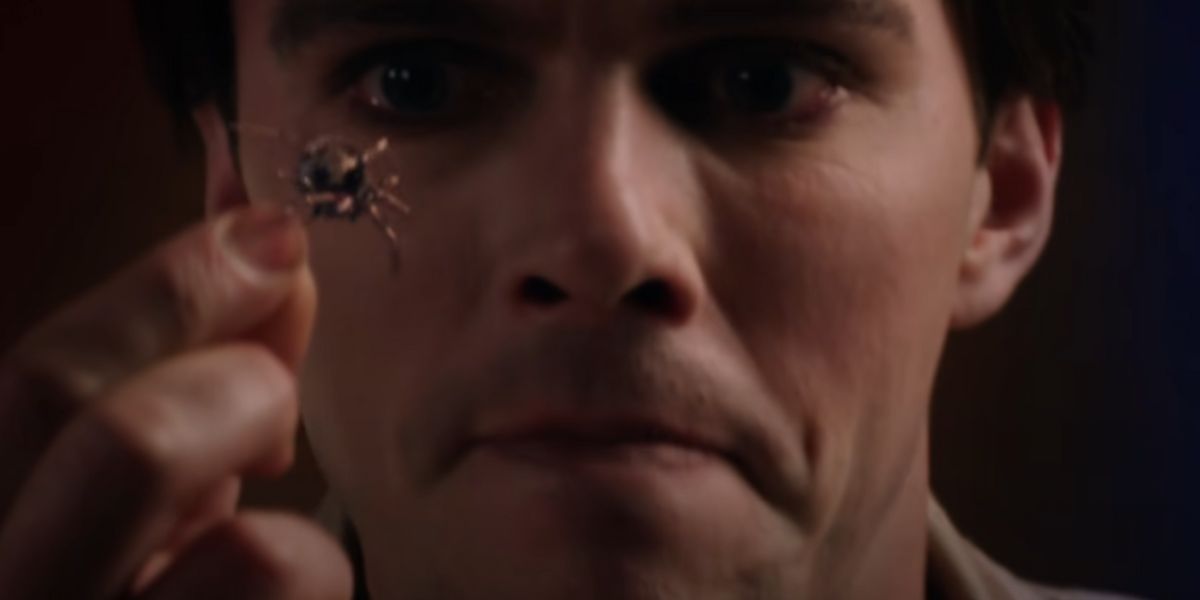 Nicholas Hoult holding up a bug in Renfield