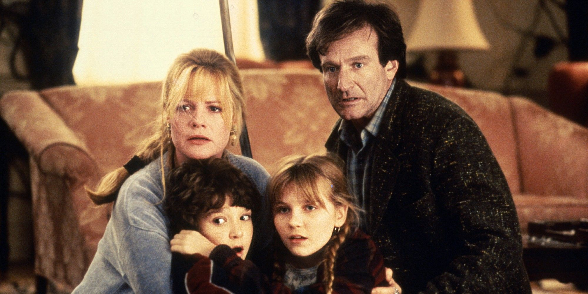 Robin Williams, Kirsten Dunst, Bonnie Hunt, and Bradley Pierce huddled together in 'Jumanji'