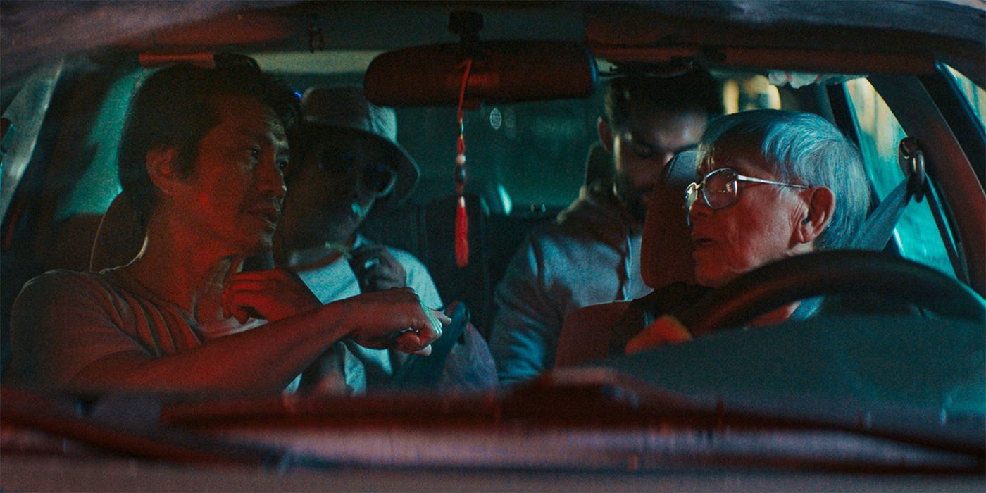 Dustin Nguyen as Tay with Hiep Tran Nghia as Long in his car in The Accidental Getaway Driver