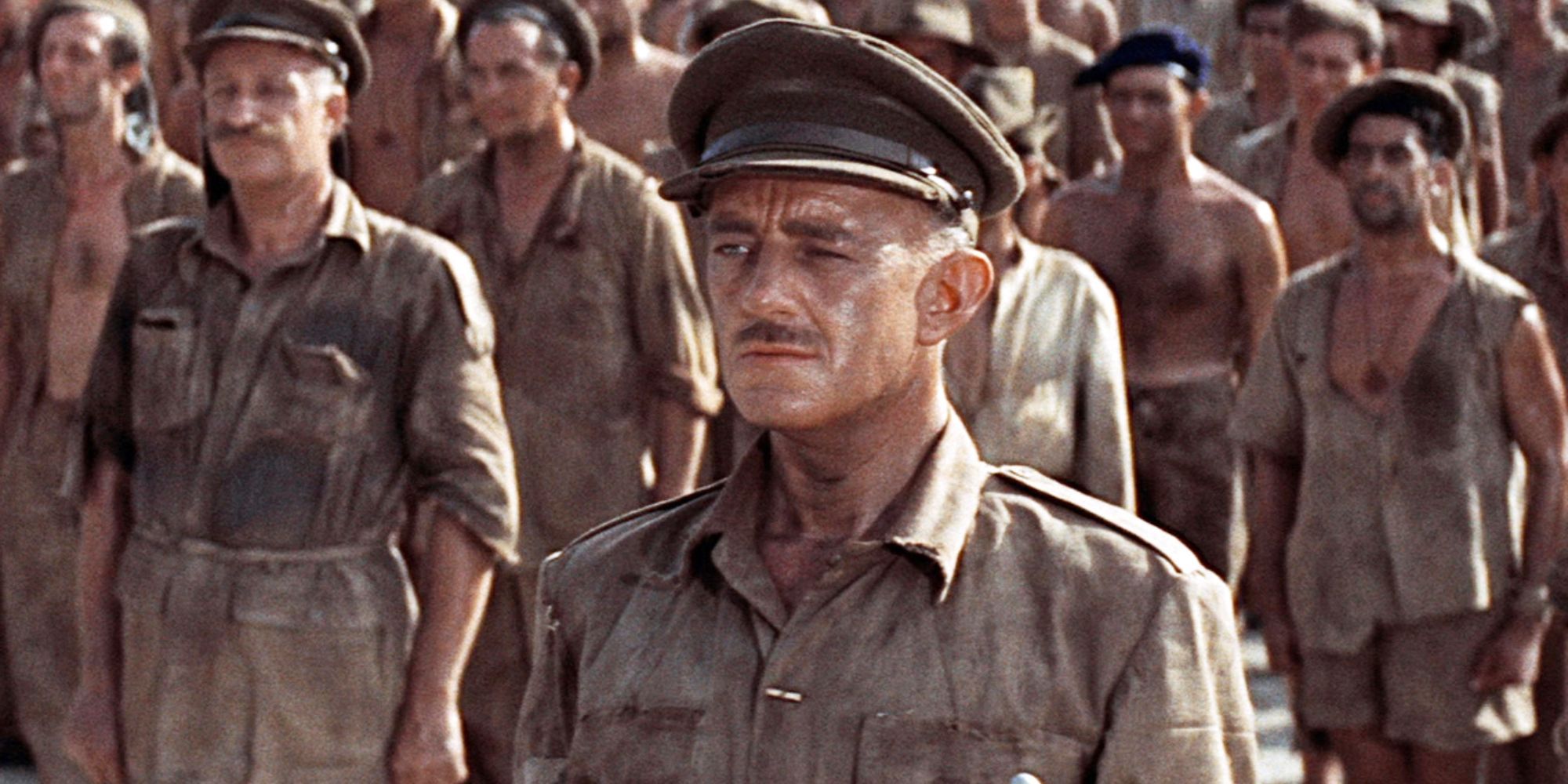 Sir Alec Guinness as Colonel Nicholson, standing in front of a group of soldiers in The Bridge on the River Kwai