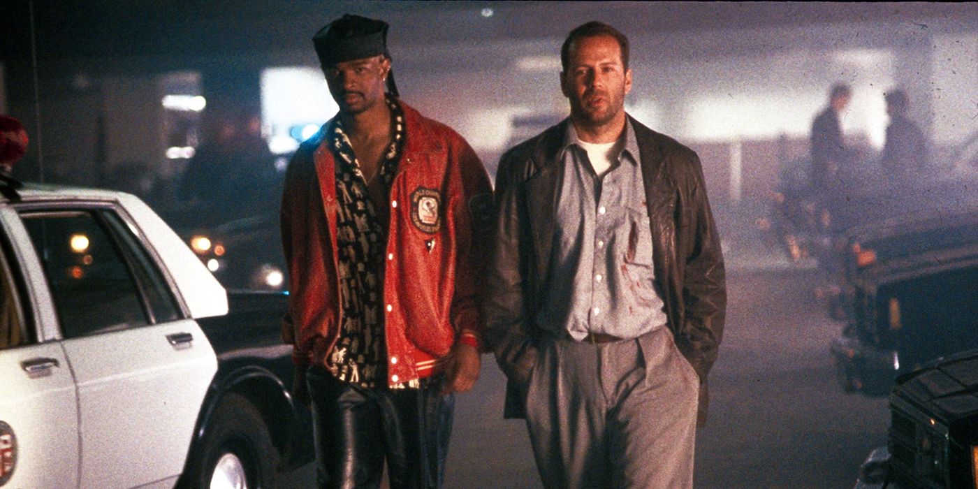 Bruce Willis and Damon Wayans standing in a parking lot in The Last Boy Scout