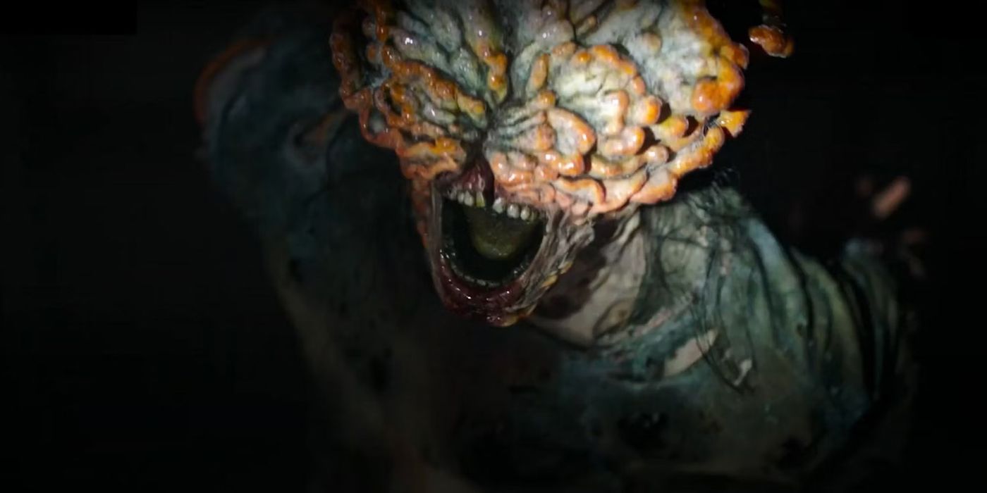 A close-up of an infected monster in The Last of Us, it's mouth open and head covered with fungus.