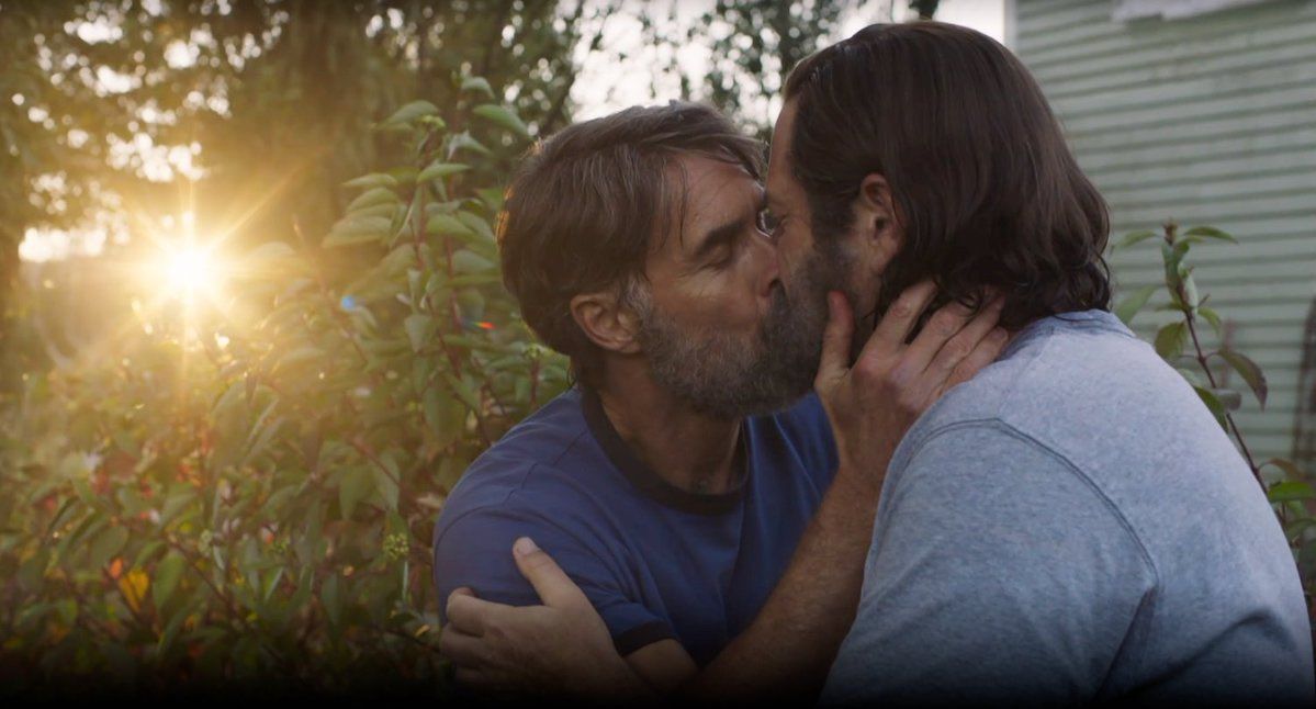 Nick Offerman as Bill and Murray Bartlett as Frank kissing in the garden in HBO's The Last of Us