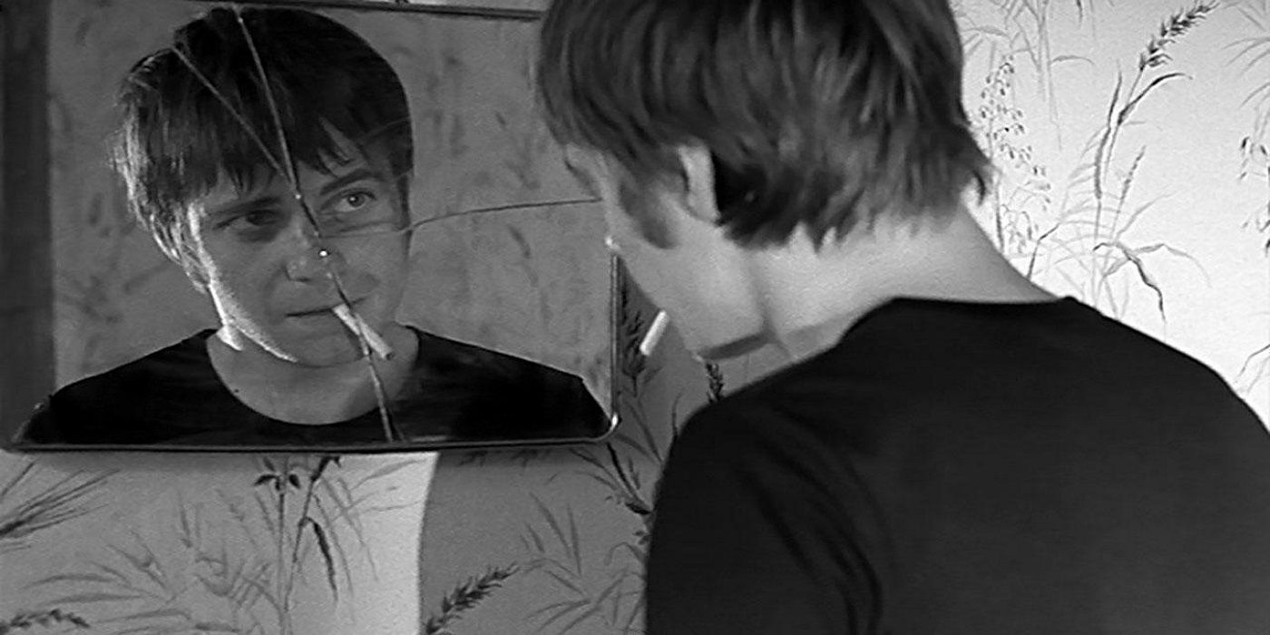 A Man smoking a cigarette and looking in the mirror in 'The Man Who Sleeps'