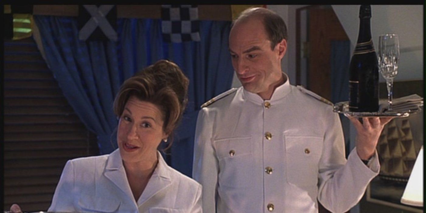Martin, played by Simon Kunz, holding a serving tray of champagne and smiling at Chessy, played by Lisa Ann Walter, in 'The Parent Trap'