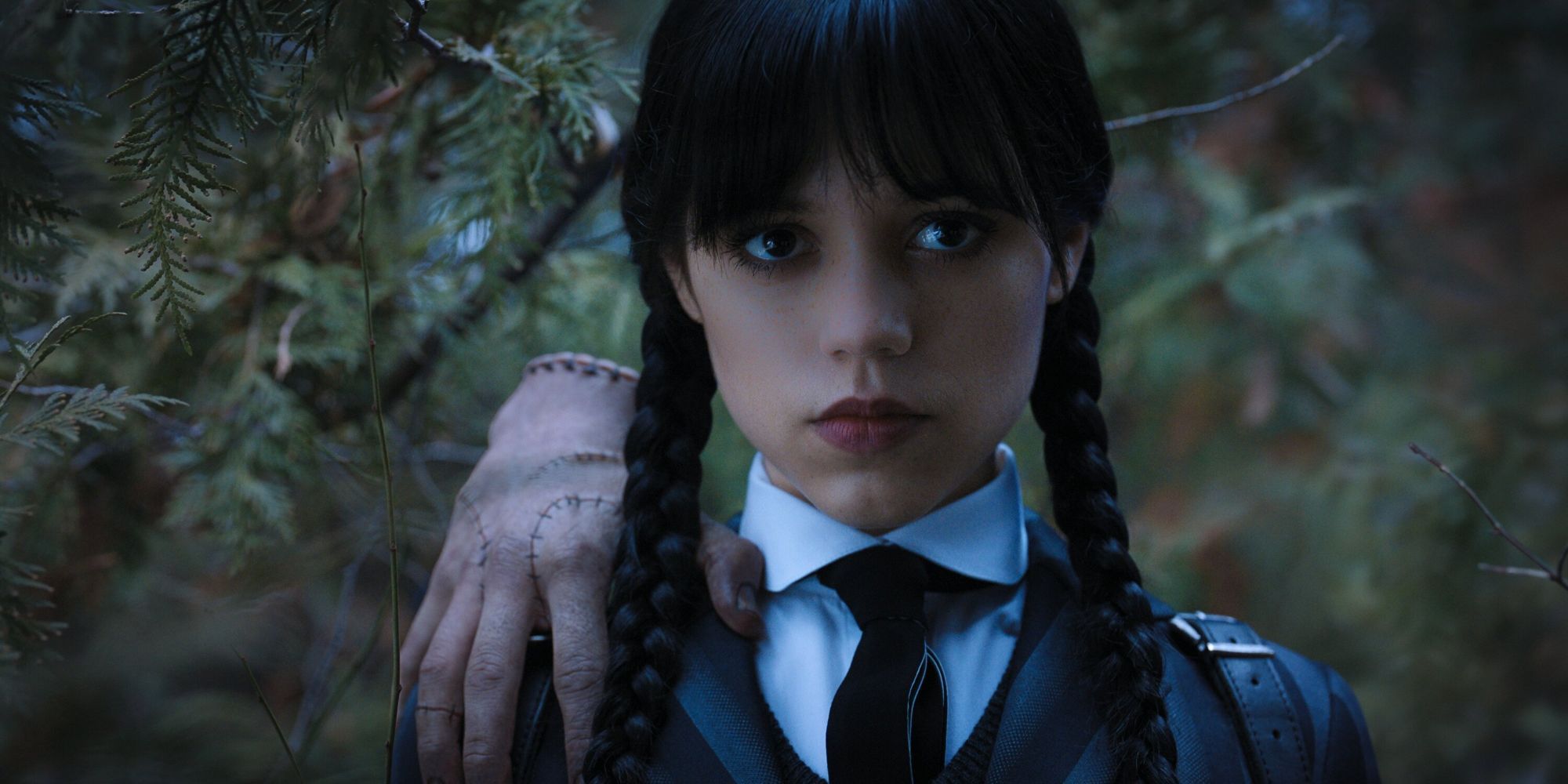 Jenna Ortega as Wednesday looking straight ahead with Thing on her shoulder in Wednesday