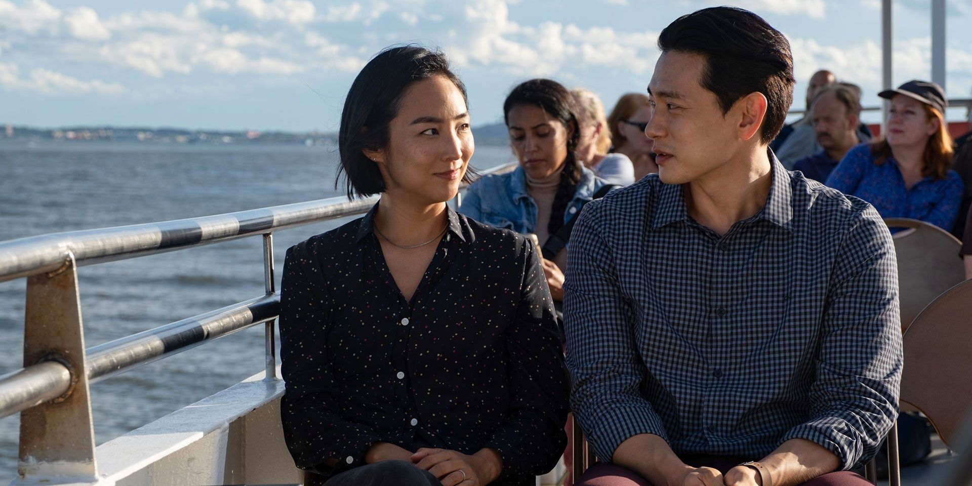 A man and a woman talking aboard a ship in the film Past Lives.