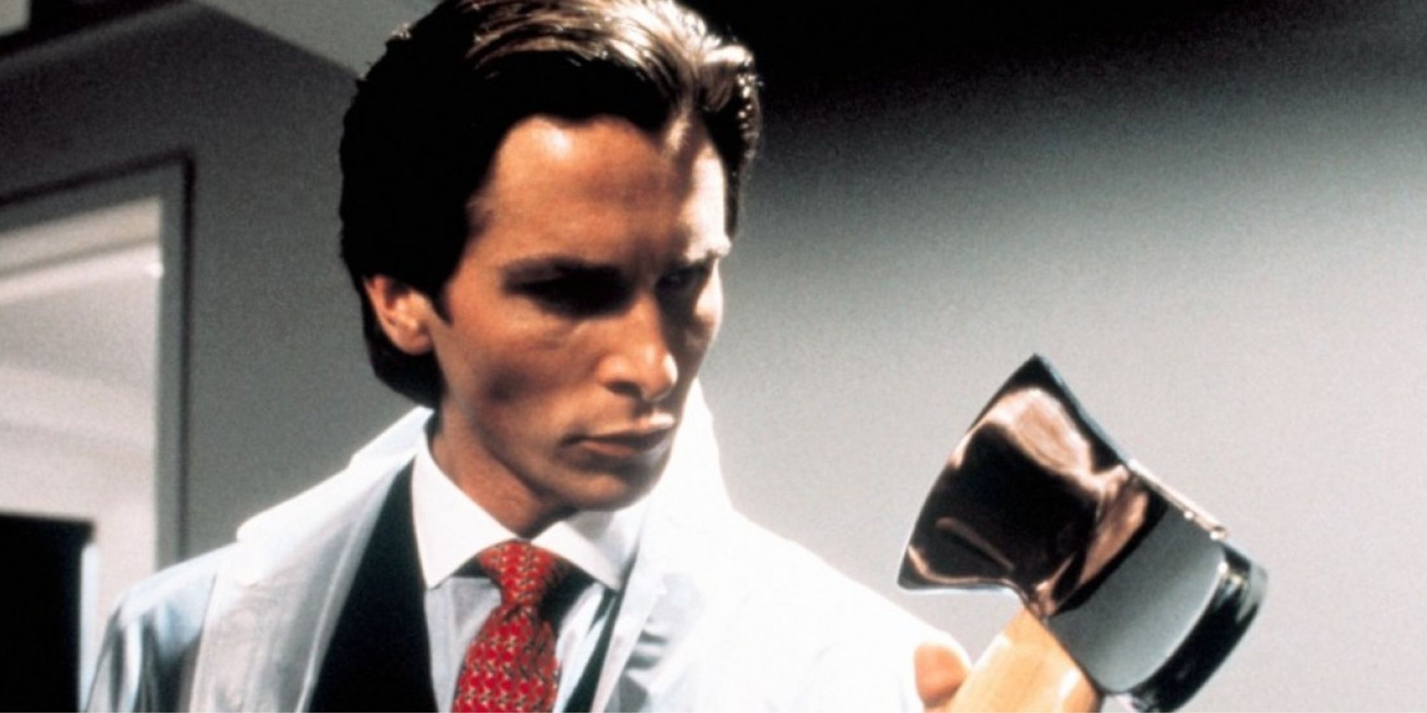 Christian Bale as Patrick Bateman in 'American Psycho', holding an axe