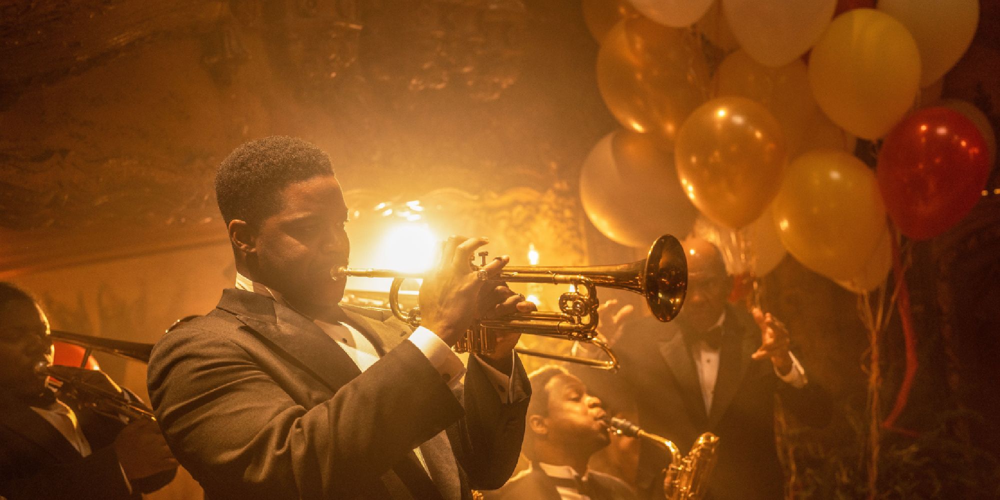 Sydney Palmer, played by Jovan Adepo, playing the trumpet in Babylon (2022)