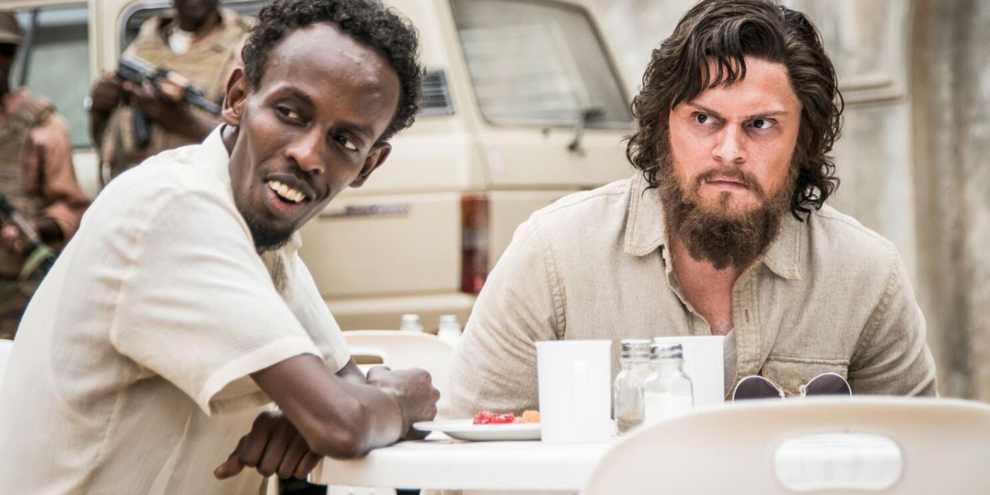 Barkhad Abdi and Evan Peters looking in the same direction in The Pirates of Somalia