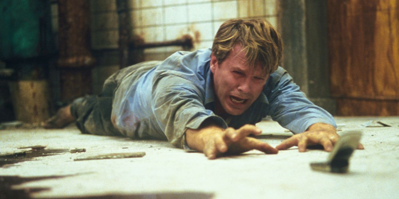 Dr. Lawrence Gordon crawling on the floor and crying in Saw 