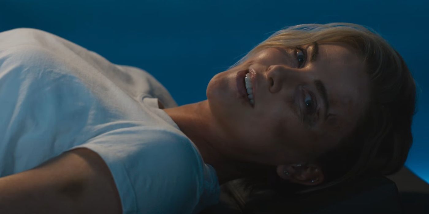 Charlize Theron as Cipher lying down and smiling in 'Fast X'.