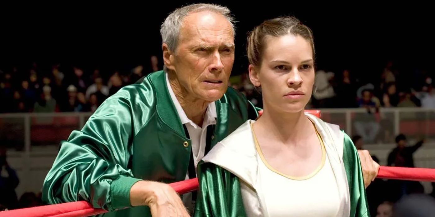 Clint Eastwood standing behind Hilary Swank in a boxing ring in a scene from Million Dollar Baby.