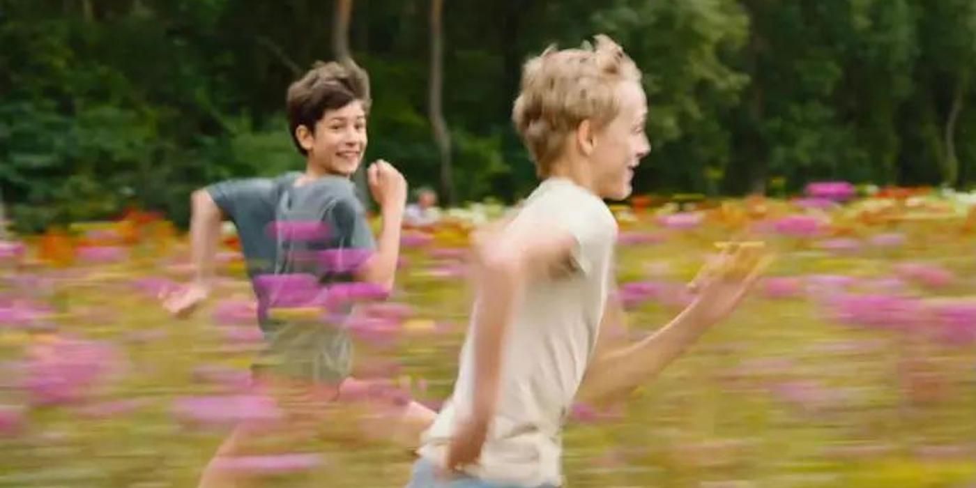 Two boys running through a field in Close 2022