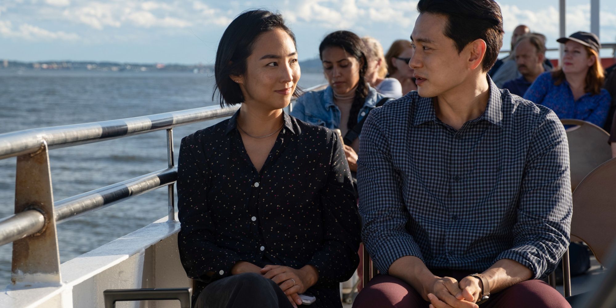 A man and a woman (Greta Lee and Teo Yoo) talk on board a ship in the film Past Lives.