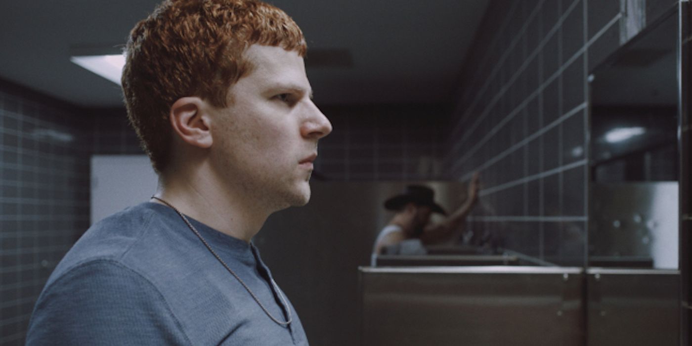Jesse Eisenberg's Ralphie staring at himself in a mirror in Manodrome