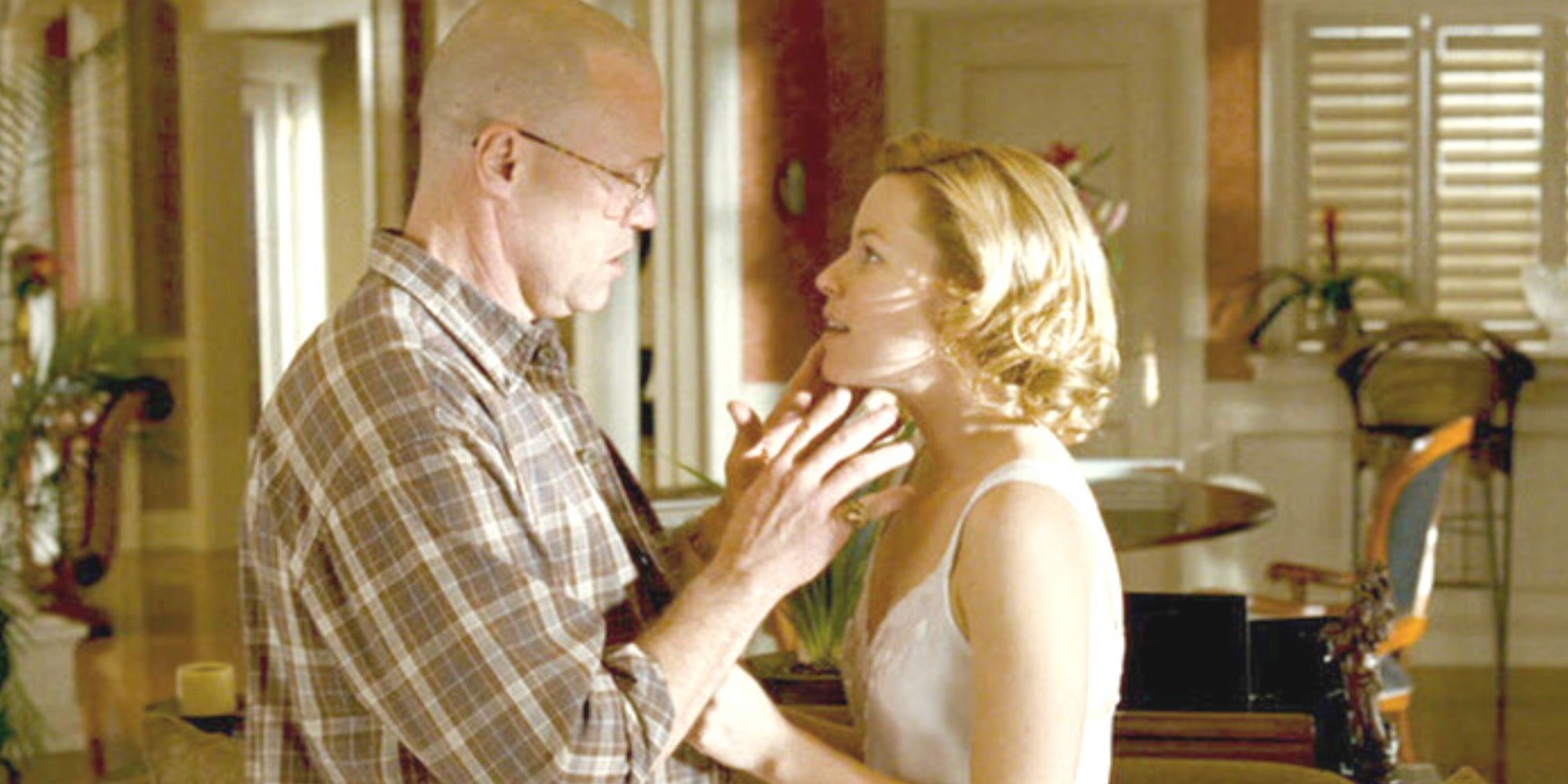 Michael Rooker facing Elizabeth Banks while talking to her in Slither