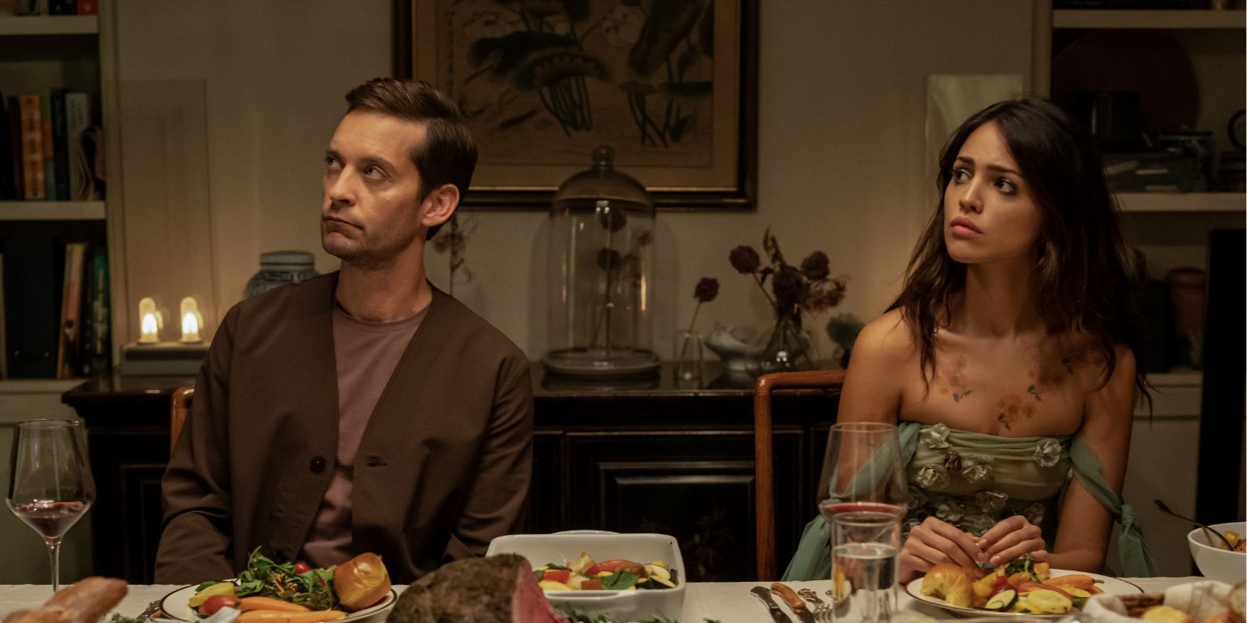 Tobey Maguire and Eiza Gonzalez at a dinner table in an episode of Extrapolations