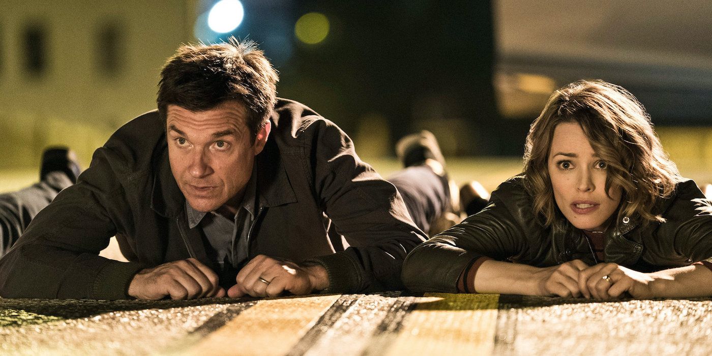 Jason Bateman and Rachel McAdams as Max and Annie, looking up while laying on the ground in Game Night