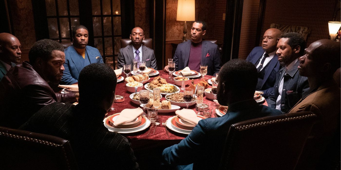 Forest Whitaker sitting at a table with other men in Godfather of Harlem Ten Harlems