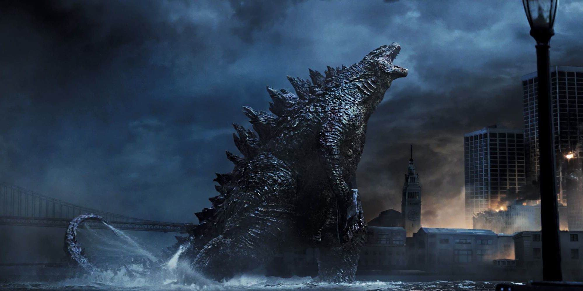 Godzilla comes out of the water and toward a city in 'Godzilla: King of the Monsters'